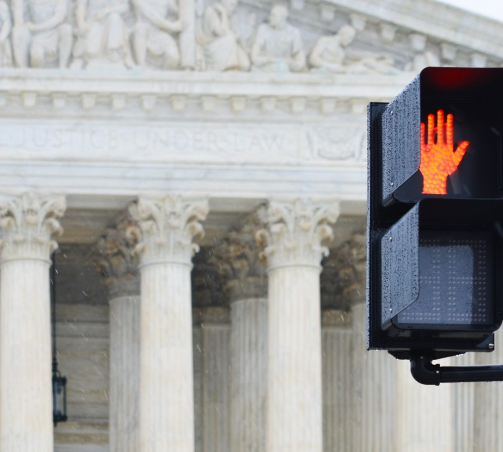 Supreme,Court,Building,And,Red,Traffic,Light,Symbolizes,A,Negative